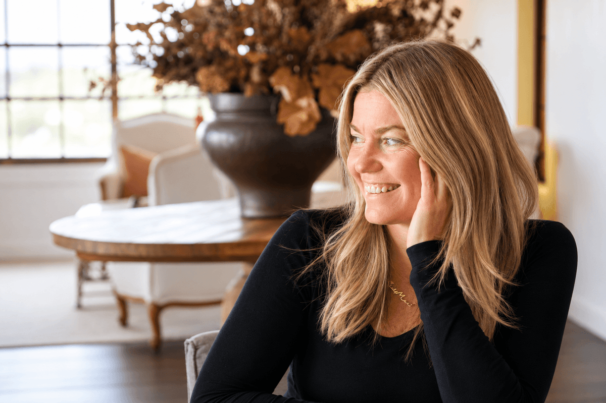 Olivia Carr seated in a sunlit room, smiling.